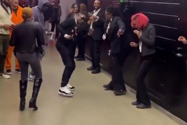 Rapper Boosie performing a dance move with Atlanta Hawks staff