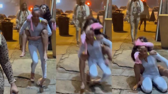 A Woman in Heels Stumbles to the Ground While Carrying Her Female Friend on Her Back